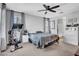 Neutral bedroom featuring a ceiling fan, large bed, and an exercise bike at 5741 W Warner St, Phoenix, AZ 85043