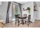 Cozy dining area with natural light, wood-look tile and a sliding glass door at 5741 W Warner St, Phoenix, AZ 85043