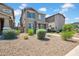Charming two-story home featuring neutral paint, desert landscaping, and inviting front porch entry at 5741 W Warner St, Phoenix, AZ 85043