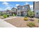 Charming two-story home featuring neutral paint, desert landscaping, and inviting front porch entry at 5741 W Warner St, Phoenix, AZ 85043