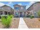 Charming two-story home featuring neutral paint, desert landscaping, and inviting front porch entry at 5741 W Warner St, Phoenix, AZ 85043