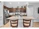 Open kitchen featuring a large island with granite countertops and stainless-steel appliances at 5741 W Warner St, Phoenix, AZ 85043