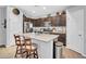 Open kitchen featuring a large island with granite countertops and stainless-steel appliances at 5741 W Warner St, Phoenix, AZ 85043