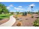 A recreational playground area with play structures, a mulch ground cover, and walking path in the community at 5741 W Warner St, Phoenix, AZ 85043
