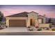 Inviting single-story home with a two-car garage, tile roof, manicured landscaping, and covered front entry at 6298 W Honors Way, Florence, AZ 85132