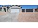 Well maintained single-story home featuring an attached two-car garage and concrete driveway at 8588 E Edgewood Ave, Mesa, AZ 85208