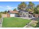Well-maintained backyard featuring lush green grass, a covered patio, and secure fencing for privacy at 917 E Lexington Ave, Gilbert, AZ 85234