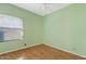 Bedroom featuring light green walls, a ceiling fan, window and laminate flooring at 917 E Lexington Ave, Gilbert, AZ 85234