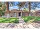 Charming brick home with mature trees and a well-manicured lawn at 917 E Lexington Ave, Gilbert, AZ 85234
