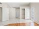 Hallway featuring white walls, multiple doorways, tiled floor and closet space at 917 E Lexington Ave, Gilbert, AZ 85234