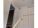 Hallway with neutral paint featuring white banister and trim leading to the upstairs bedrooms and bathroom at 921 W University Dr # 1191, Mesa, AZ 85201