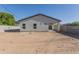 Spacious backyard with dirt and block fence, and a covered patio at 9310 W Washington St, Tolleson, AZ 85353