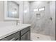 Modern bathroom features tiled shower with a built-in niche and a gray vanity at 9310 W Washington St, Tolleson, AZ 85353