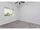 Bright bedroom with cozy carpet and a sunlit window, creating a welcoming space at 9310 W Washington St, Tolleson, AZ 85353