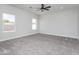 Expansive carpeted bedroom featuring three windows, offering ample natural light, and modern ceiling fan at 9310 W Washington St, Tolleson, AZ 85353