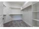 Walk-in closet featuring shelving for organization and storage, complete with plush carpeting at 9310 W Washington St, Tolleson, AZ 85353
