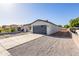 Charming single story home featuring a low maintenance yard, long driveway, and a gray color scheme at 9310 W Washington St, Tolleson, AZ 85353