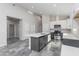 Modern kitchen featuring white cabinets, a gray island with a sink, and stainless steel appliances at 9310 W Washington St, Tolleson, AZ 85353