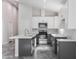 Open kitchen featuring white cabinets, a gray island with a sink, and stainless steel appliances at 9310 W Washington St, Tolleson, AZ 85353