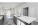 Open kitchen with gray island, stainless steel appliances, recessed lighting and gray tile floors at 9310 W Washington St, Tolleson, AZ 85353
