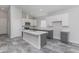 Bright kitchen featuring white cabinets, gray island, modern appliances, and stylish tile floors at 9310 W Washington St, Tolleson, AZ 85353