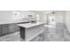 Modern kitchen featuring white cabinets, a gray island, and stainless steel appliances at 9310 W Washington St, Tolleson, AZ 85353