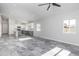 Bright living room with ceiling fan, gray tile floors, recessed lighting, and an open layout at 9310 W Washington St, Tolleson, AZ 85353