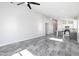 Spacious living room featuring gray tile floors, recessed lighting, and an open concept design at 9310 W Washington St, Tolleson, AZ 85353