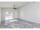 Bright living room with access to backyard featuring gray tile floors, recessed lighting, and a ceiling fan at 9310 W Washington St, Tolleson, AZ 85353