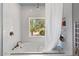 This bright bathroom offers a tub and shower, white marble and a lovely view of desert landscaping at 9607 E Mckellips Rd, Mesa, AZ 85207