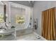 This bright bathroom offers a tub and shower, white marble, a towel warmer, and a lovely view at 9607 E Mckellips Rd, Mesa, AZ 85207
