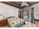 This bedroom has beamed ceilings, a sliding glass door to the backyard, and brick accents at 9607 E Mckellips Rd, Mesa, AZ 85207