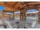 Outdoor patio area with seating, a brick fireplace, and views of the pool at 9607 E Mckellips Rd, Mesa, AZ 85207