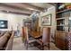 Formal dining room with wood table, chandelier, exposed beams, and tile flooring at 9607 E Mckellips Rd, Mesa, AZ 85207