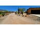 Gravel driveway leading to a home with mountain views at 9607 E Mckellips Rd, Mesa, AZ 85207