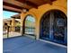 Inviting covered entrance with arched door and window at 9607 E Mckellips Rd, Mesa, AZ 85207