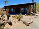Inviting home exterior with desert landscaping, arched windows, and ample curb appeal at 9607 E Mckellips Rd, Mesa, AZ 85207