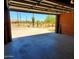 Open garage showcasing desert landscaping, providing ample parking and convenient access to outdoor space at 9607 E Mckellips Rd, Mesa, AZ 85207