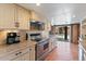 Well-lit kitchen featuring stainless steel appliances and terracotta flooring at 9607 E Mckellips Rd, Mesa, AZ 85207