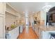 Bright kitchen featuring white cabinets, tile backsplash, and terracotta floors at 9607 E Mckellips Rd, Mesa, AZ 85207