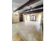 Bright, open living area features exposed wood beams, neutral color palette, and decorative chandeliers at 9607 E Mckellips Rd, Mesa, AZ 85207