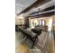 Bright, open living area features exposed wood beams, neutral color palette, and decorative chandeliers at 9607 E Mckellips Rd, Mesa, AZ 85207
