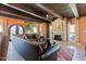 Open living room with exposed beams, a fireplace, and views of the outdoors at 9607 E Mckellips Rd, Mesa, AZ 85207