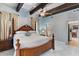 This main bedroom boasts a four-poster bed, beamed ceilings, and a doorway to other rooms at 9607 E Mckellips Rd, Mesa, AZ 85207