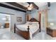 This main bedroom boasts a four-poster bed, beamed ceilings, and a doorway to the bathroom at 9607 E Mckellips Rd, Mesa, AZ 85207