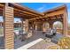 Spacious outdoor living area with a fireplace, bar, and multiple seating options, ideal for gatherings at 9607 E Mckellips Rd, Mesa, AZ 85207