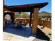 Covered patio with brick columns providing shade and an outdoor dining space with desert landscaping at 9607 E Mckellips Rd, Mesa, AZ 85207