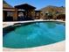 Stunning pool with desert landscape and outdoor covered seating area perfect for entertaining and relaxation at 9607 E Mckellips Rd, Mesa, AZ 85207