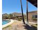Backyard pool area with desert landscaping, covered seating, and mountain views, creating a private oasis at 9607 E Mckellips Rd, Mesa, AZ 85207