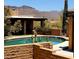 Spectacular backyard pool surrounded by desert landscape and a luxurious outdoor seating area at 9607 E Mckellips Rd, Mesa, AZ 85207